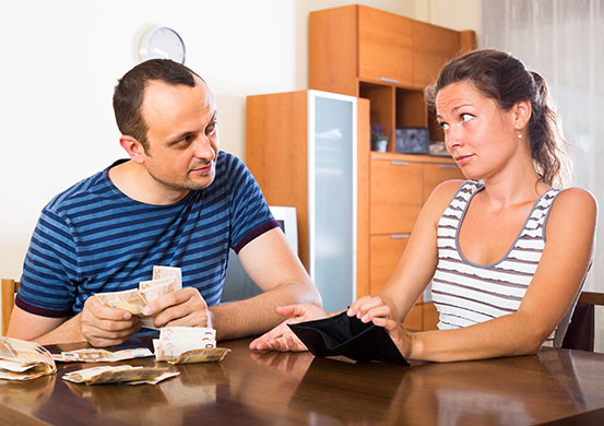 Young woman and her husband counting budget for a month